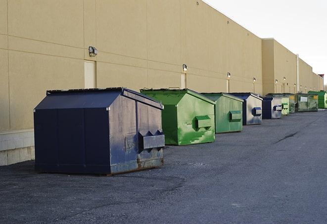 an empty dumpster ready for use at a construction site in Belle Glade